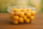 500 grams of yellow dates in a plastic container 